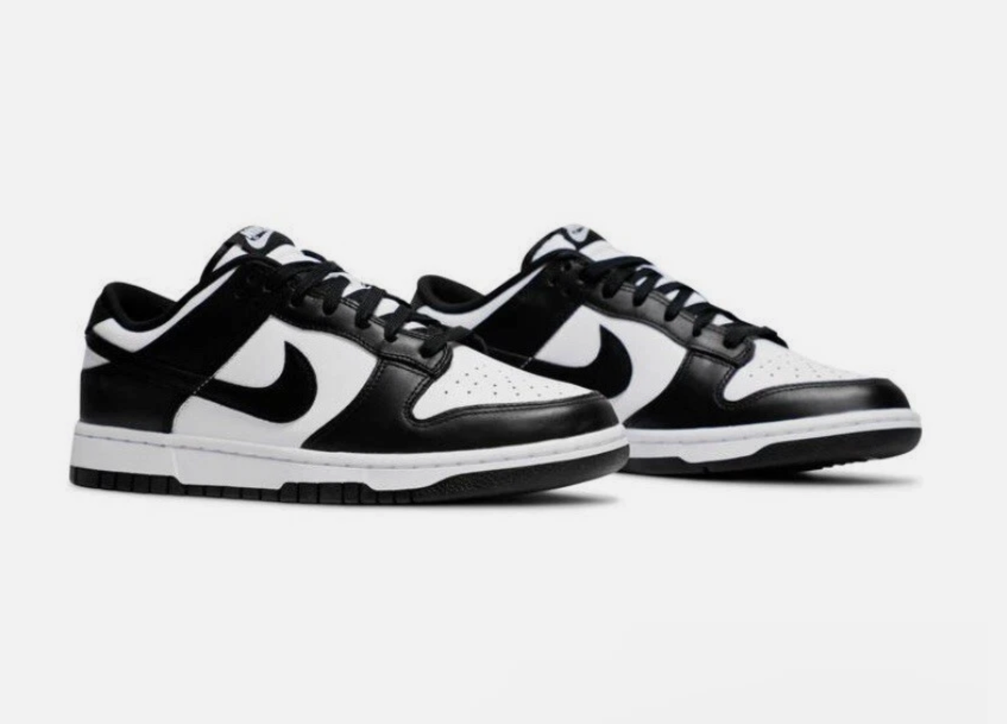 Black and white sneakers with a Nike logo on a white background